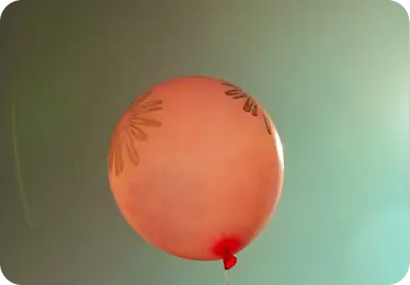 Balloon floating against a soft sky
